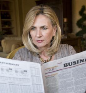 Mature woman reading the financial news