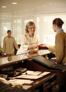 Woman checking in at the hotel reception desk