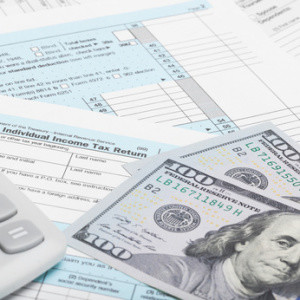 US Tax Form 1040 with calculator and dollars - 1 to 1 ratio