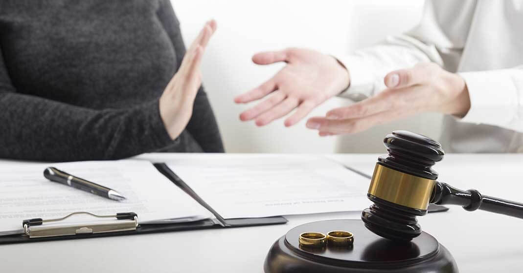 man and woman in dispute, gavel with wedding bands, contract, challenging a prenuptial agreement in florida